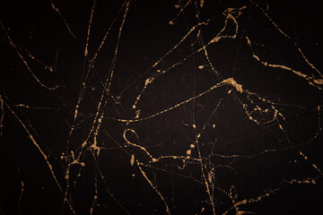 Gold and black marble art pattern. Textured abstract background.
