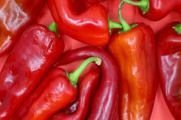 raw red peppers on a red background