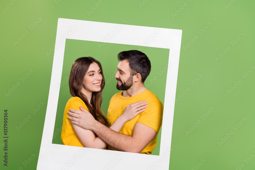 Sticker Portrait of attractive lady handsome guy cuddle look each other camera card isolated on green color background