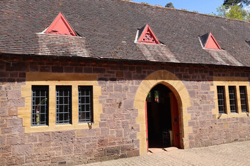 The arched doorway into the visitor centre at an English country home. They are converted stables...