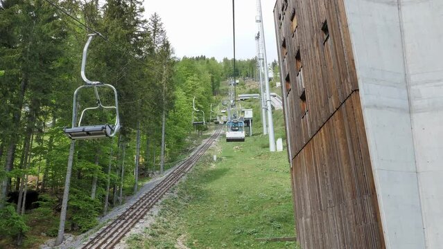 Chair ski lift at Planica Ski jump resort in Slovenia. Going up the hill. 4k 50 fps shot