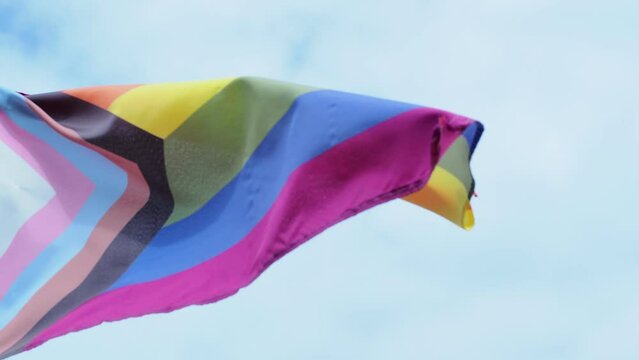 Rainbow flag fluttering at the beach