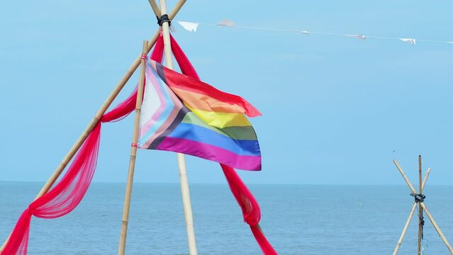 Rainbow flag fluttering at the beach