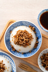 Taiwanese savory rice pudding Wa gui with chopped dried radish and soy sauce