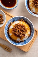 Taiwanese savory rice pudding Wa gui with chopped dried radish and soy sauce