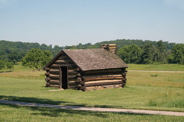 Single Log Cabin with Chimney on Grassy Field with Path at Valley Forge