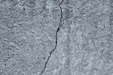 Old cracked concrete wall texture. Broken rough gray cement slab abstract grunge textured background