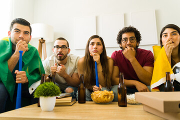 Anxious sports fans feeling tense while watching a soccer world cup on tv