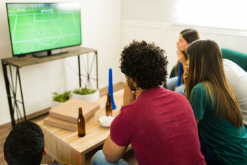Sports fans looking worried while watching the soccer championship
