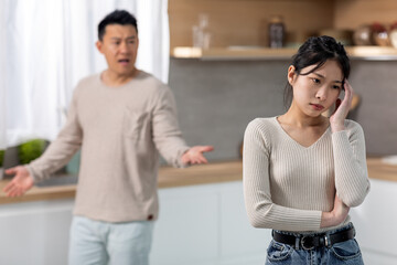 Upset young asian woman thinking about divorce