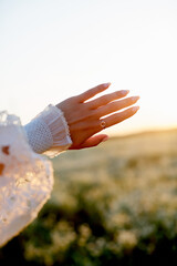 girl's hand playing with sun