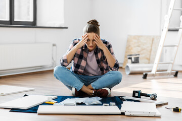 repair, improvement and furniture concept - stressed woman assembling new locker at home