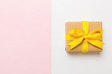 holiday paper present tied yellow ribbon bow top view with copy space. Flat lay holiday background. Birthday or christmas present. Christmas gift box concept with copy space - Powered by Adobe