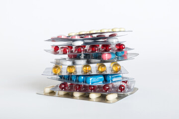 too many different pill cartridges stacked. selective Focus. Packs of blister pills with tablets. Colored pastilles packages. A pile of medicine in blister packs. Pharmaceutical blister packs