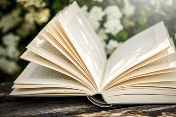 open book on a blurred background of flowers