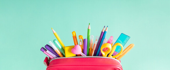 Back to school concept. Bright school pencil case with filling school stationery, pens, pencils,...