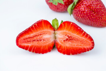 Group of summer fresh juicy strawberries in a cut on a white isolated background