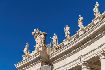 Fototapeta na wymiar View of the colonnade with statues of saints surrounding St. Peter's Square