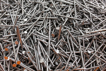 A lot of silver metal tack nails. Construction background