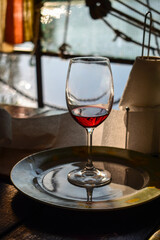 Red wine in a glass in the evening sunlight close up