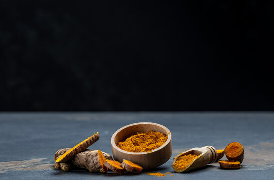 curcuma or curcumin root. Turmeric powder and fresh turmeric. on concrete background. Spice, natural coloring, alternative medicine. Long banner format. top view