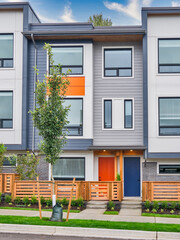 Red and blue doors of brand new residential townhouses