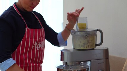 Woman Used Electric Food Processor To Chop Potatoes In The Kitchen. - close up