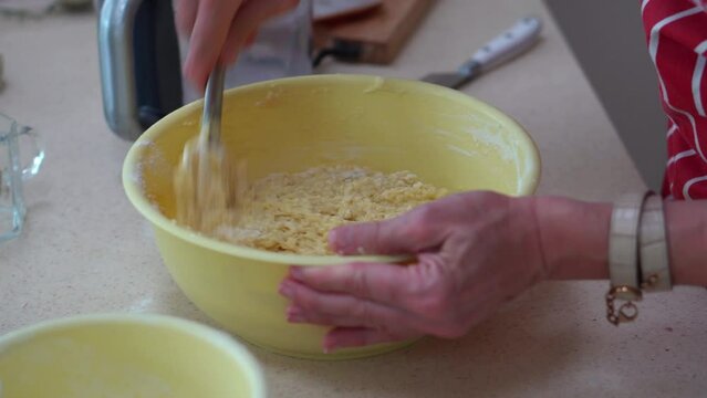 Preparing Bryndzove Halusky Dumpling. Mixing Cooked Potato Dough And Soft Sheep Cheese In A Bowl. close up