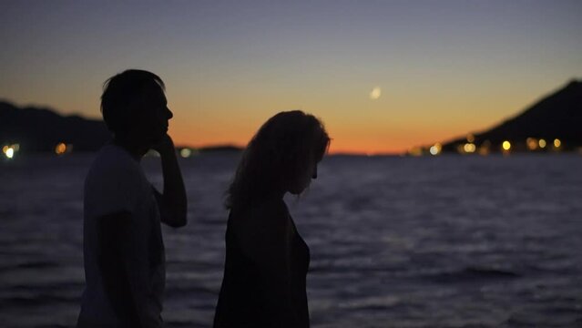 Two Adults Peacefully Walking By The Seaside In An Island At Dusk In Croatia. Selective Focus