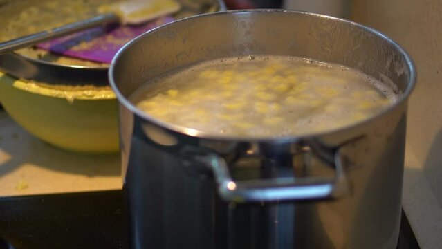 Cooking Potato Dough Lumps In A Pot With Boiling Water. Bryndzove Halusky Recipe. close up