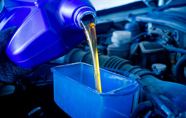 new oil into car, pouring fresh oil, service car station
