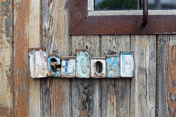 Rustic welcome greeting sign hanging on wooden door