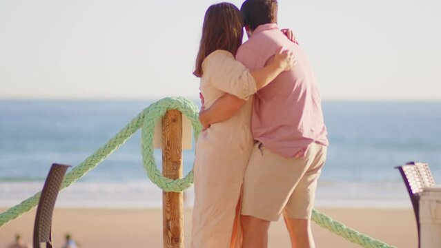 A lovely couple hugging in the viewpoint of the beach of Conil de la Frontera, Cádiz