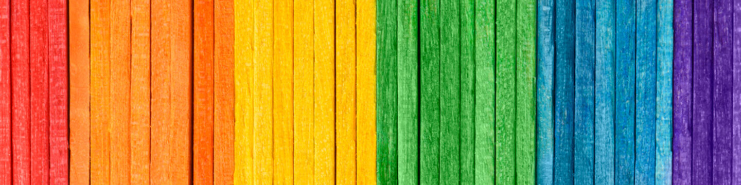 Rainbow LGBT pride flag crafted from thin wooden boards. Tolerance and diversity concept. Symbol of sexual minorities from painted wooden boards arranged vertically. Wooden rainbow banner.