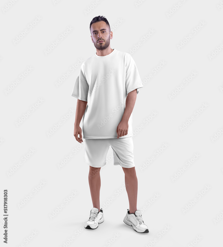 Wall mural white fashion suit mockup, oversized t-shirt, shorts on a bearded guy in sneakers, front view, isola