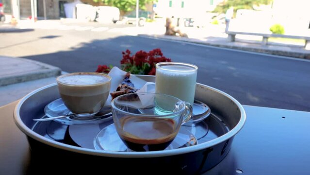 Various coffees, just surved outdoor on a terrace. Espresso, Cappucino and a babycino