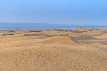 Small person in the sand dunes on a summer day