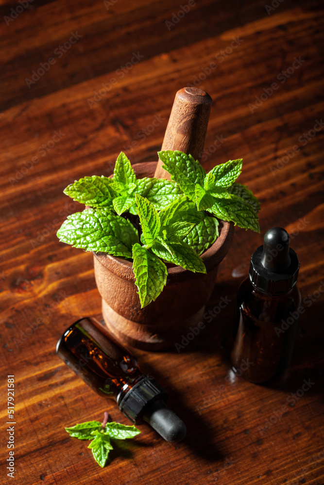 Sticker fresh mint Peppermint herb leaves in mortar and essential oil in dropper bottles