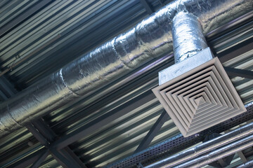 Supply grille for industrial ventilation in an office building under the ceiling, hvac engineering communications