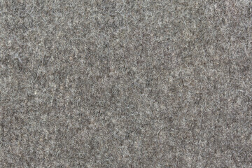 Natural grey felt as an abstract background. Texture and pattern of wool