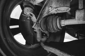 Leaks of lubricants, oil on the rubber seal, boot, swivel mechanism of the vehicle chassis, service and repair. Replacing the front anti-roll bar bushings on a car. Black and white