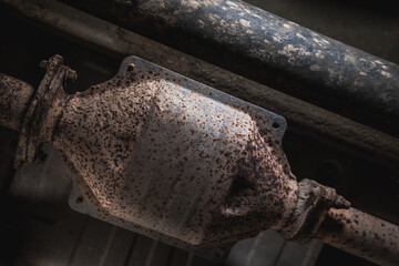 Close-up of Catalytic Converter in Car Exhaust System. The concept of preserving ecology, reducing harmful emissions into the air. legal regulations for vehicles with internal combustion engines