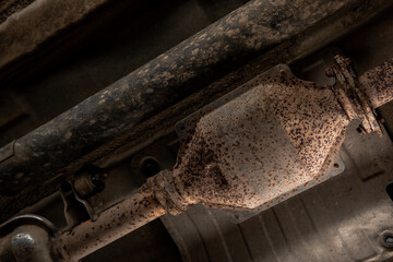 Close-up of Catalytic Converter in Car Exhaust System. The concept of preserving ecology, reducing harmful emissions into the air. legal regulations for vehicles with internal combustion engines