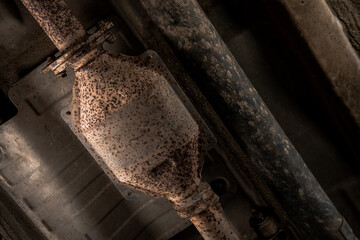 Close-up of Catalytic Converter in Car Exhaust System. The concept of preserving ecology, reducing harmful emissions into the air. legal regulations for vehicles with internal combustion engines