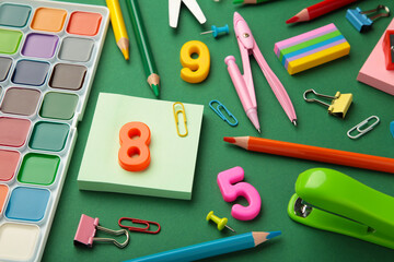 Different stationery on green background, flat lay with space for text. Back to school