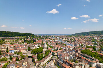 Fototapeta premium Aerial view of cityscape of City a sunny with local mountain in the background summer day. Photo taken June 20th, 2022, Zurich, Switzerland.