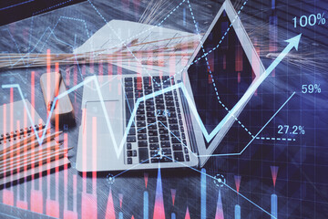 Stock market graph and table with computer background. Multi exposure. Concept of financial analysis.