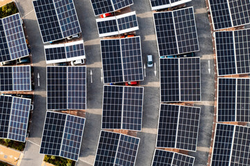 Aerial view of solar panels on a parking lot rooftop