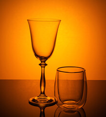 a wine glass and a mulled wine glass on an orange background