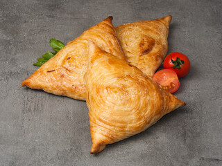 three samsas on a gray background. close-up